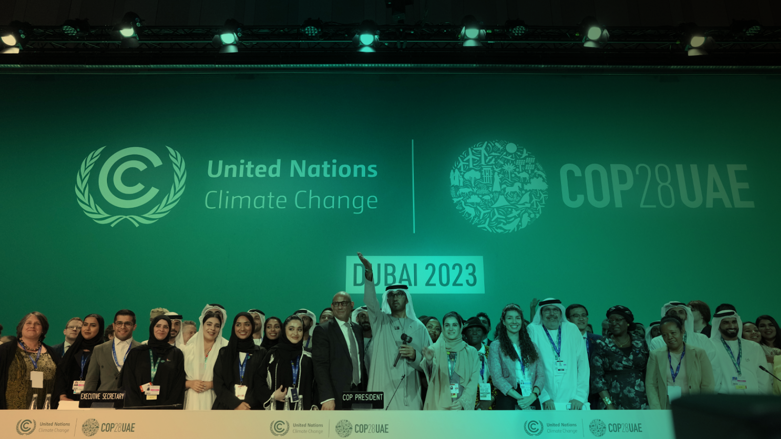 Conference attendees pose for photos at the end of the COP28 U.N. Climate Summit in Dubai, United Arab Emirates.