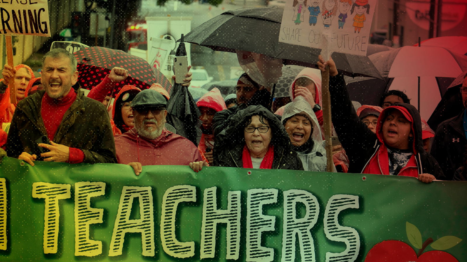 Teachers and supporters hold signs at a rally (AP Photo/Ringo H.W. Chiu)