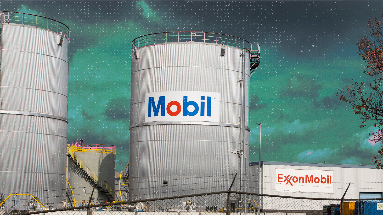 Exxon Mobil storage tanks behind a chain link fence topped with razor wire.