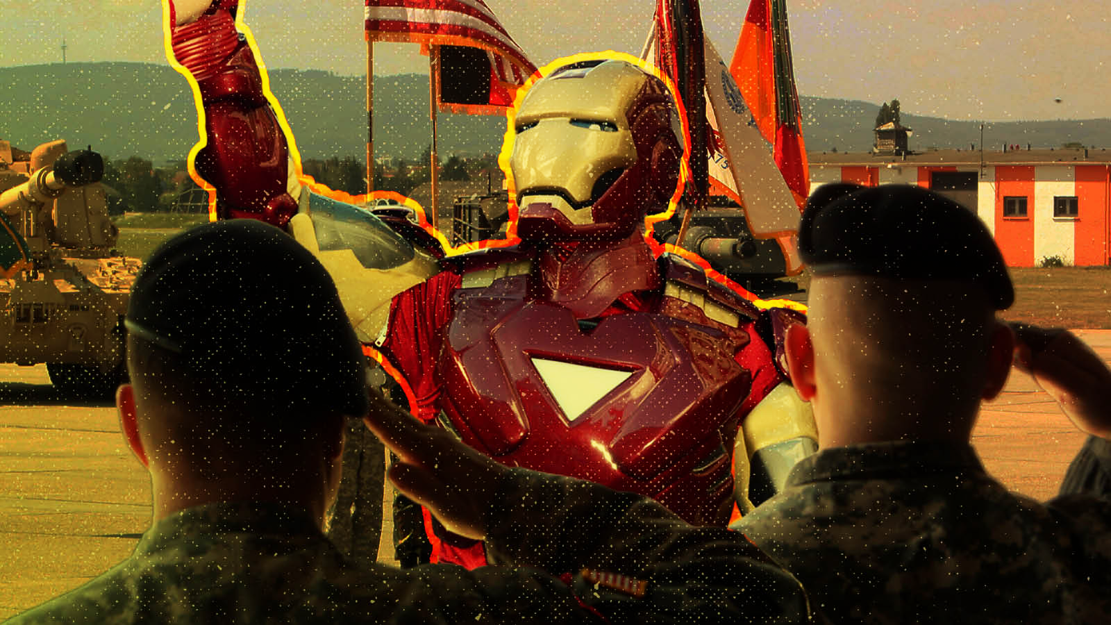 In a composite image, Marvel’s Iron Man is seen in the distance as U.S. servicemen salute