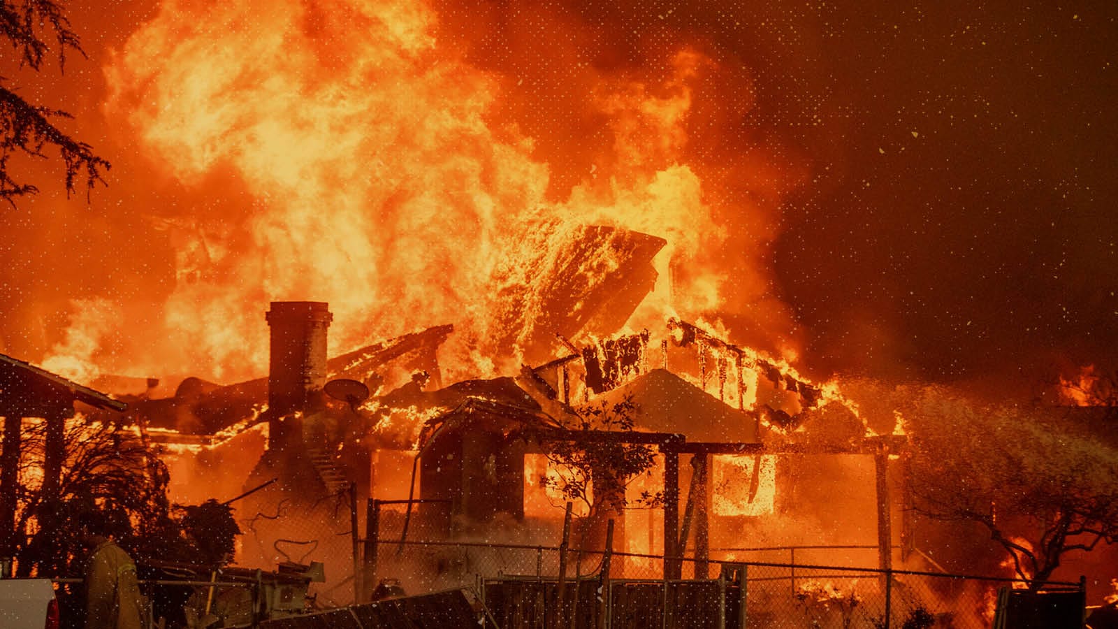 The Eaton Fire burns a structure on Jan. 8, 2025, in Altadena, Calif. (AP Photo/Ethan Swope)