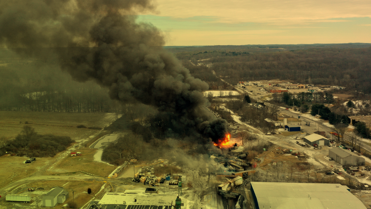 Portions of a Norfolk and Southern freight train that derailed in East Palestine, Ohio, in 2023, on fire.