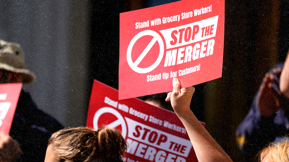 Union members protest against the proposed merger of grocery store chains Kroger and Albertsons on Sept. 30, 2024.