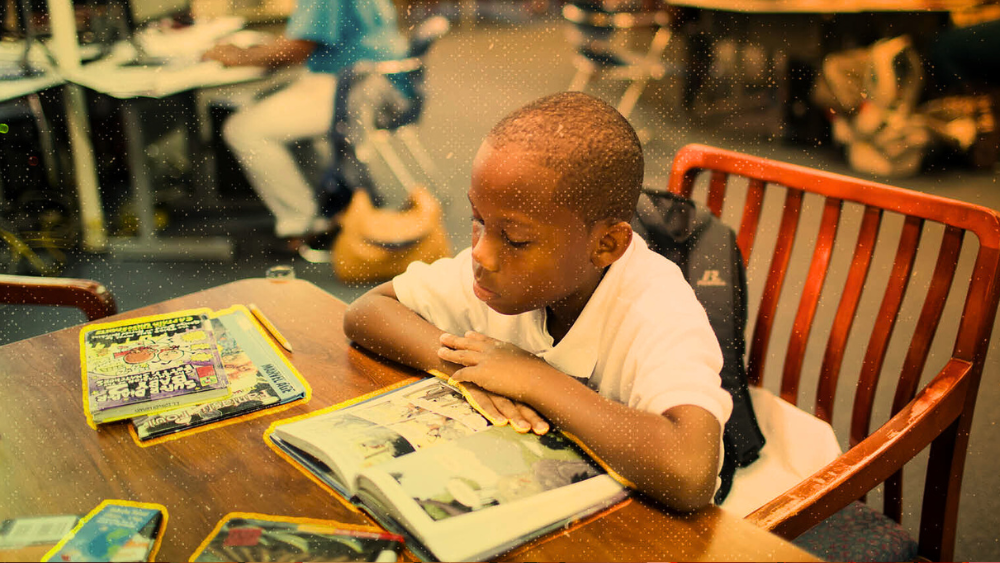 An elementary school student reads at his school library. (AP Photo/Brynn Anderson)