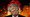 A photo of a smiling Donald Trump is overlaid on a massive explosion.